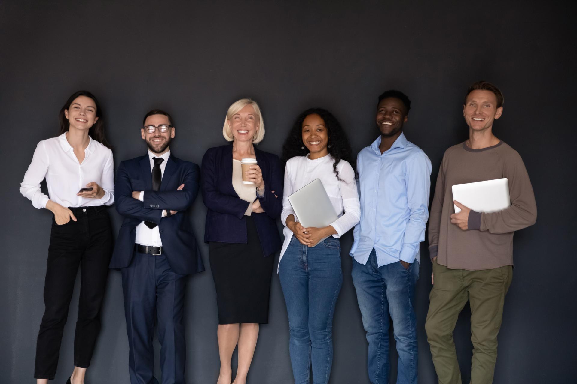 Group picture of multiethnic employees posing in office together